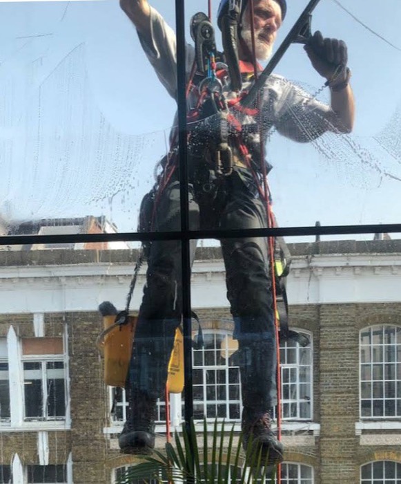 Rope-access window cleaning on a tall London building